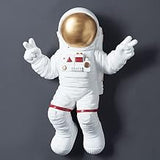 BYVUTE Astronaut Wall Decoration Figurine, Wall-Mounted Resin Wall Sculpture with Hanging Spaceman Planet Moon for Ornament Indoor Living Room Kid's Space Themed Room Gifts (Gold)