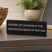 Lavex Please Let Us Know If The Restroom Needs Attention Sign - Black and White, 9" x 3" - lifestyle