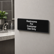 Lavex Restrooms For Customer Use Only Sign - Black and White, 9" x 3" - lifestyle